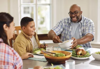 Two parents with a child having dinner