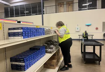 Teenager works to restock food before the market opens