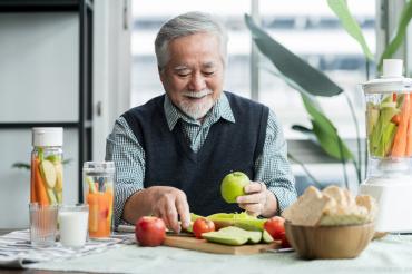Asian elder senior male making a healthy snack