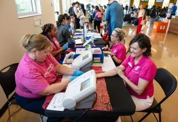 Woman receiving health and blood pressure screening