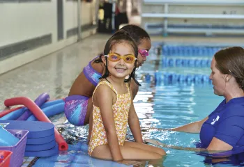little girl smiling in the pool