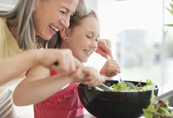 Grandmother and grand daughter cooking together