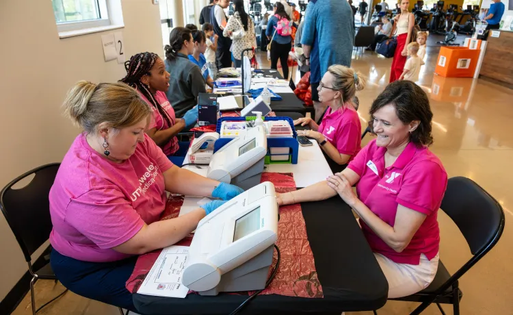 Woman receiving health and blood pressure screening
