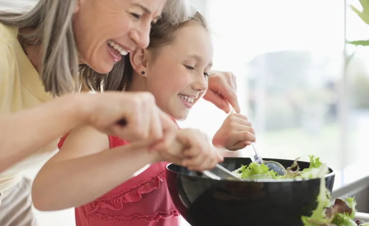 Grandmother and grand daughter cooking together