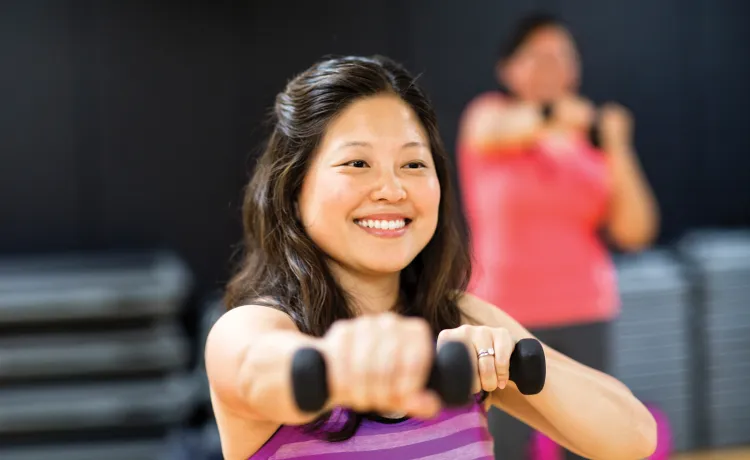 Lady holding weights during a group exercise class