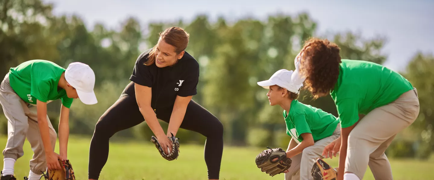 Youth playing baseball with coach