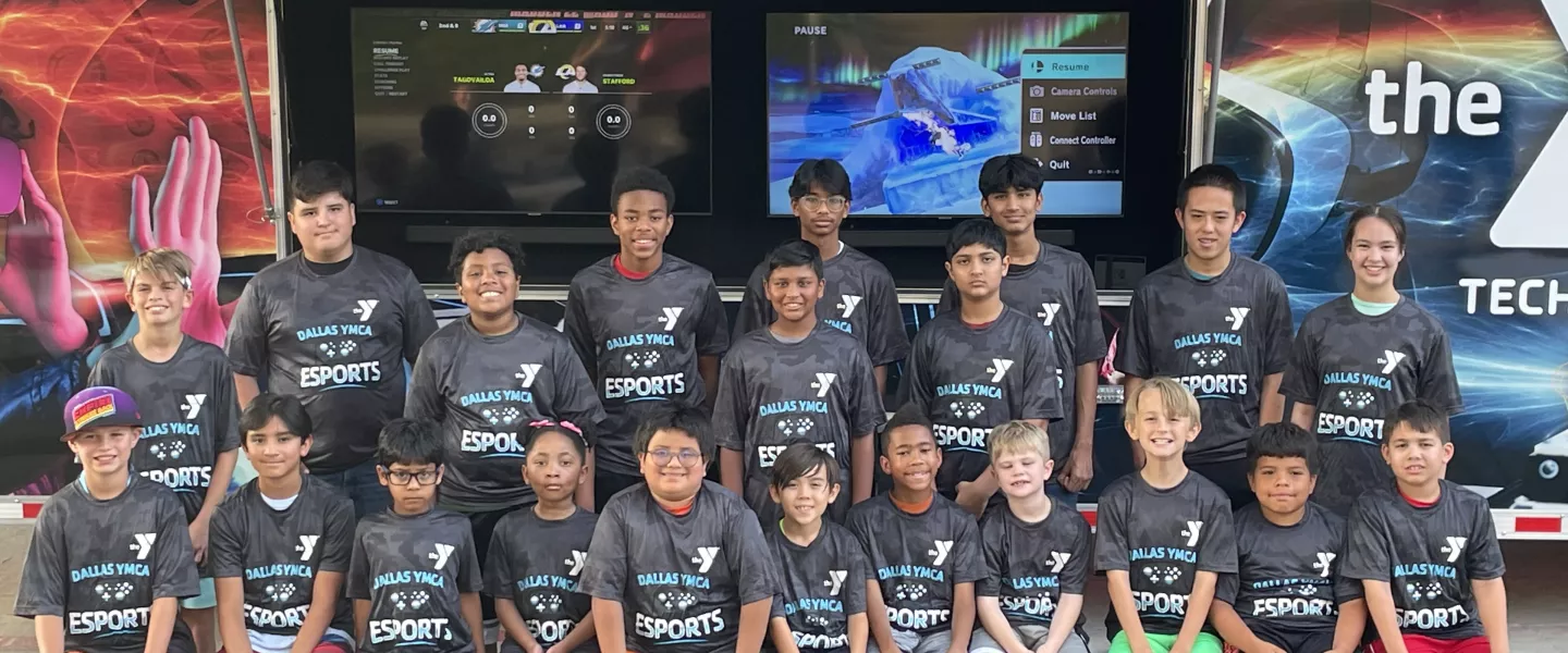 ymca esport team pose in front of gaming truck