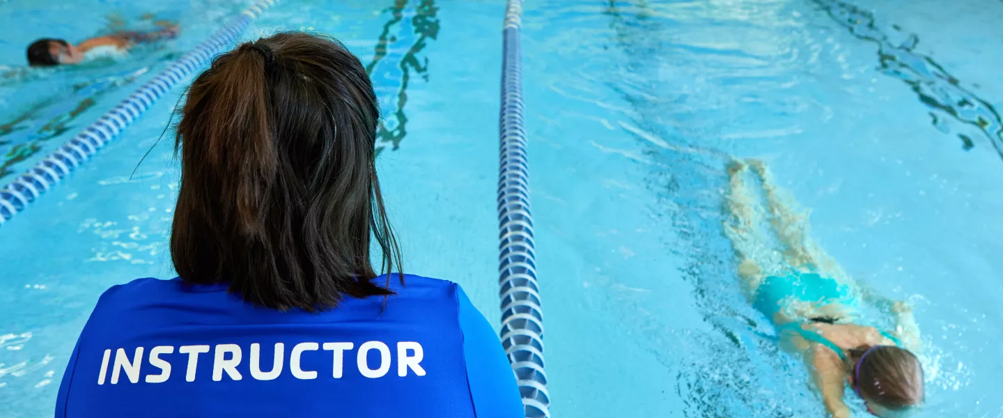 Swim instructor watching swimmers