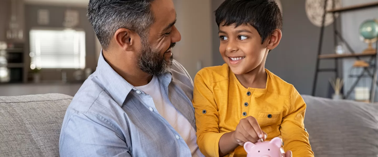 father with son and piggy bank