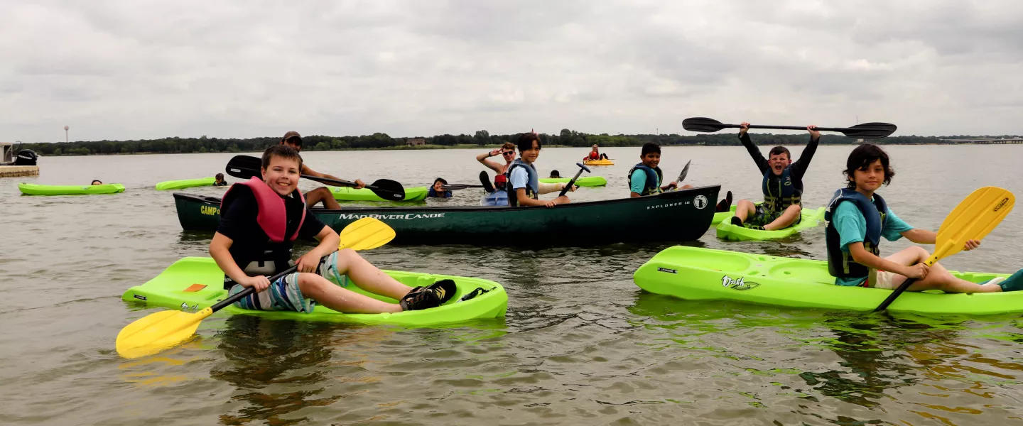 Kayaks and Canoes on the water.