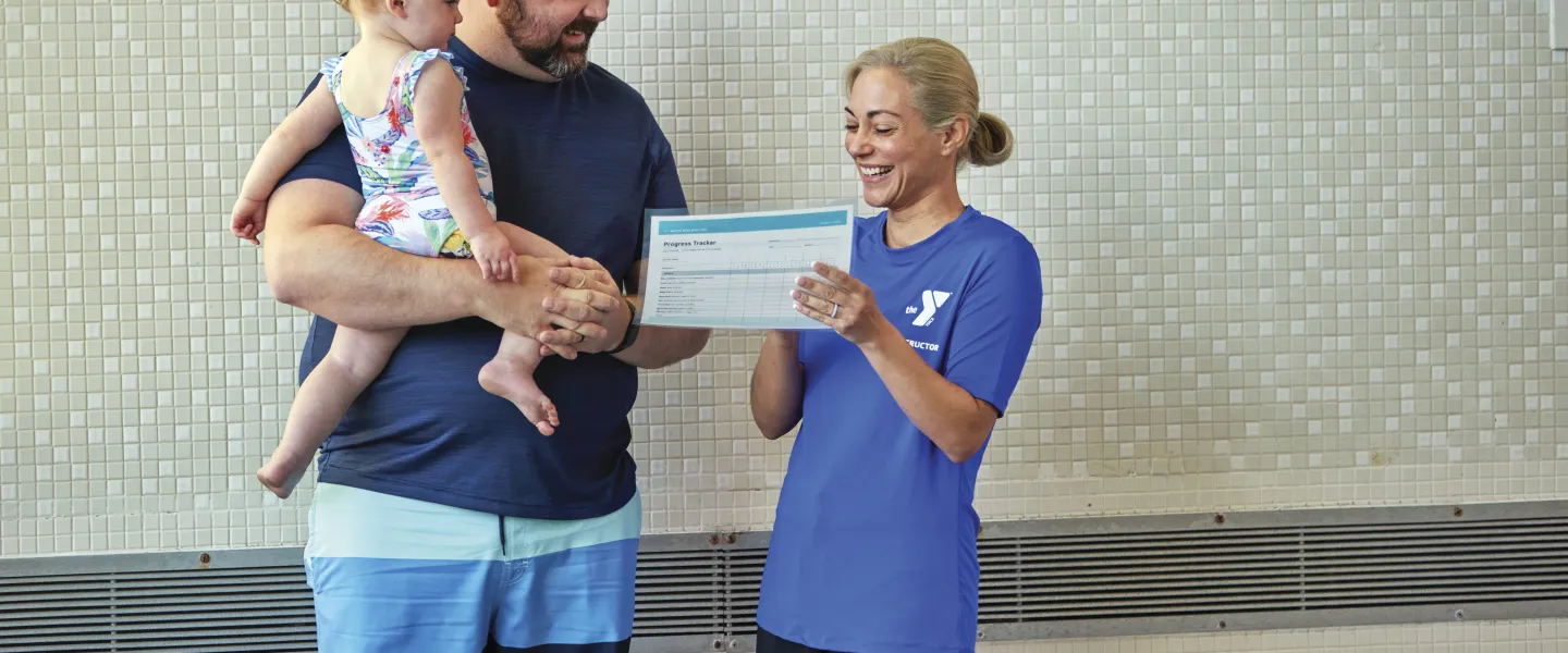 parent with child and swim instructor