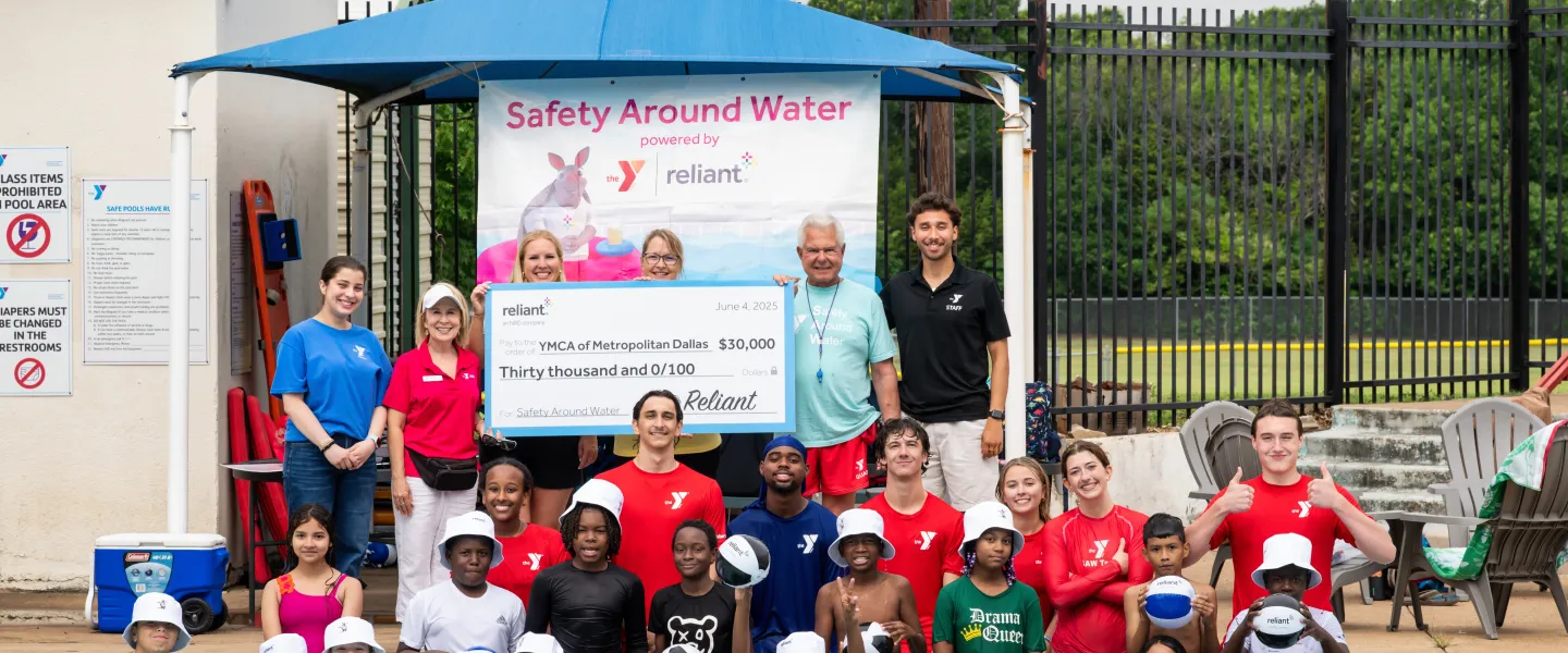 Reliant Energy with the YMCA staff and swim lesson participants with the $30,000 donation check