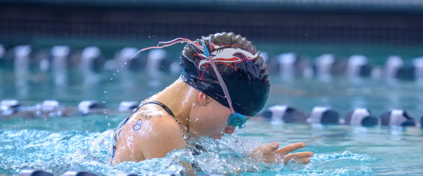 swimmer with black cap and shark on it