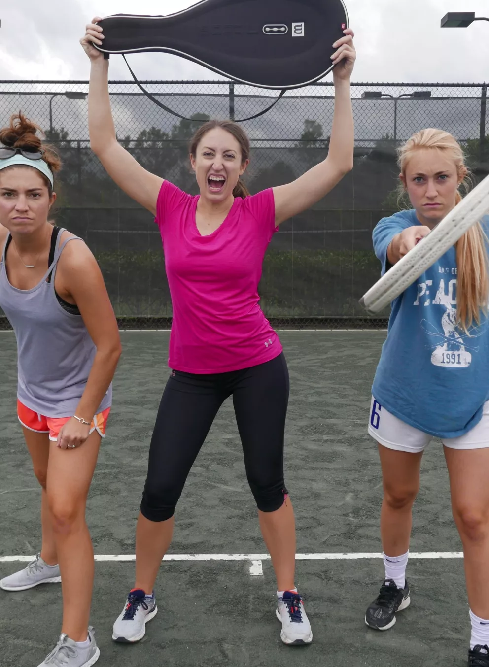 three women on tennis court