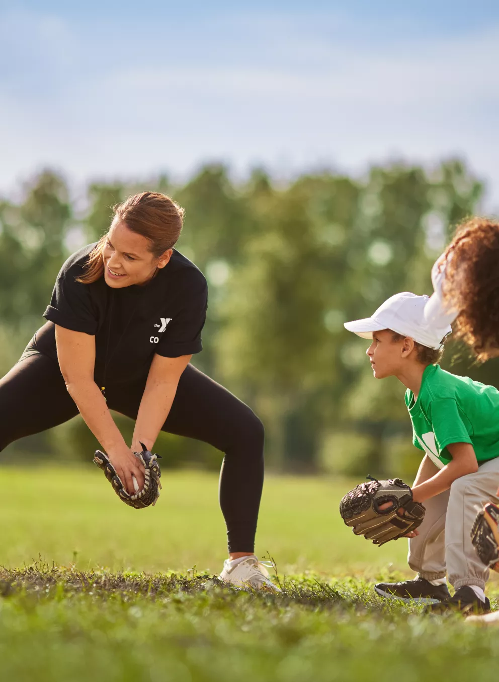 Youth playing baseball with coach