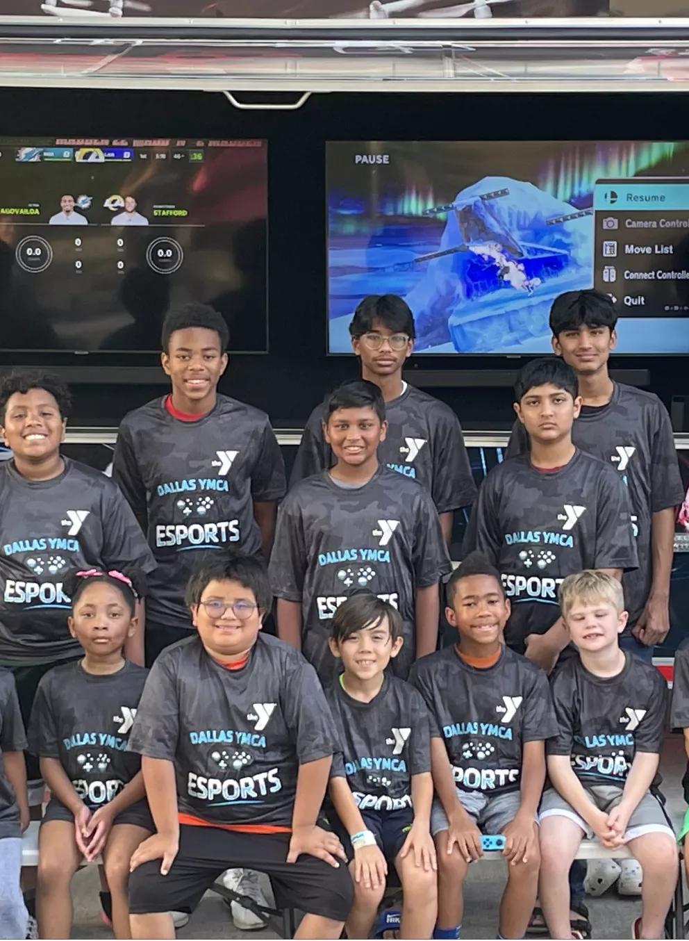 ymca esport team pose in front of gaming truck