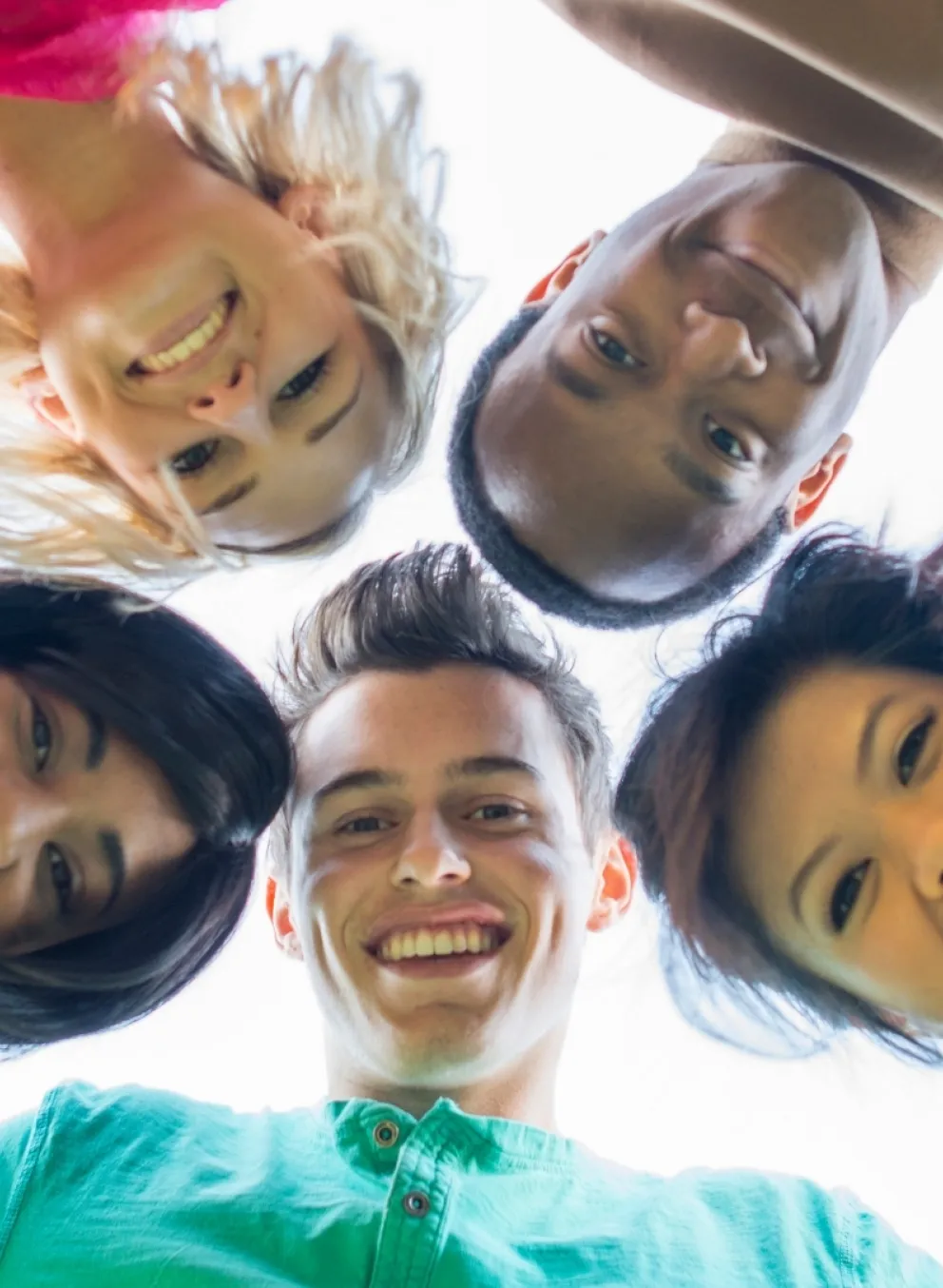 People putting their heads together in a circle