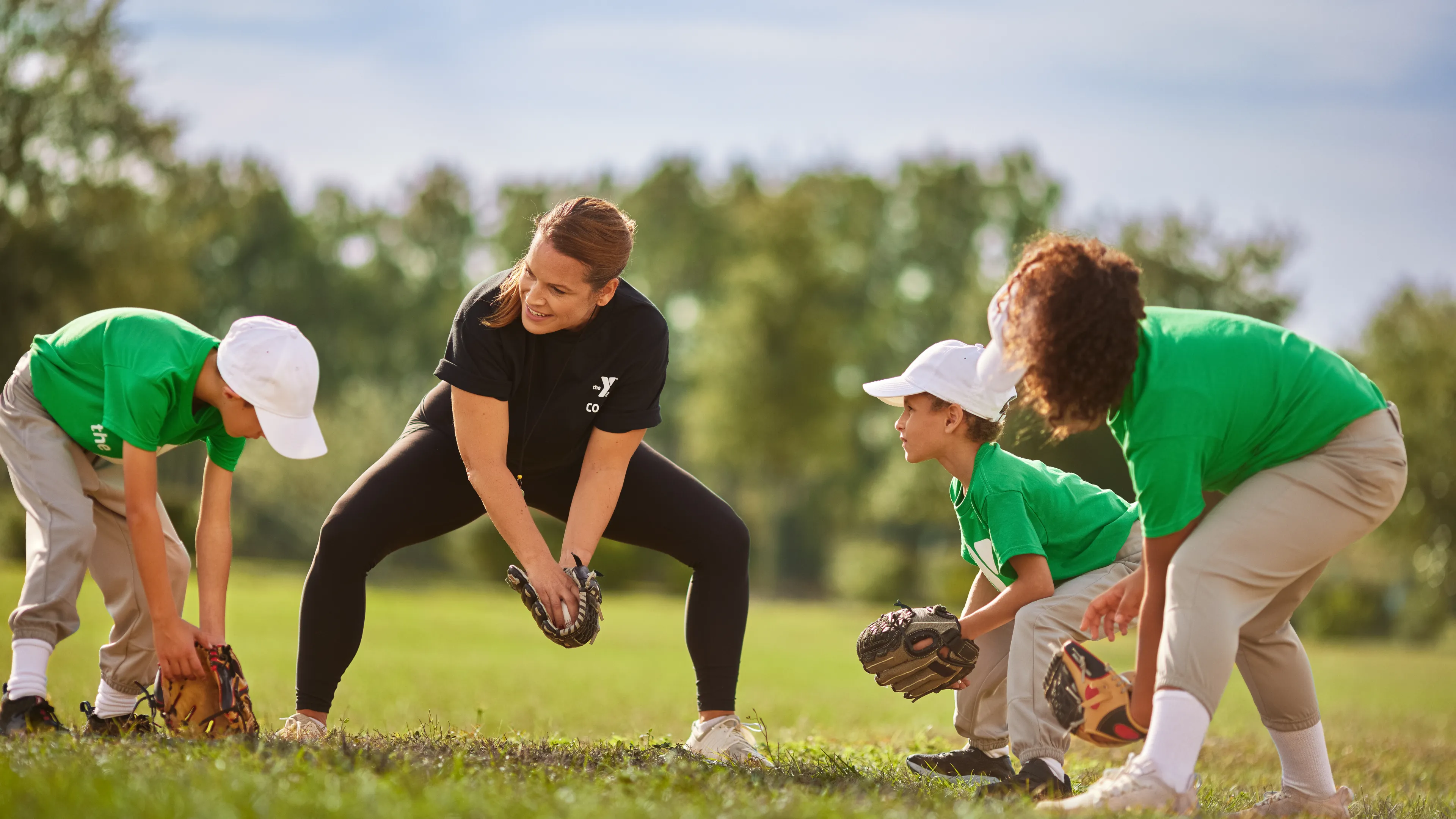 Youth playing baseball with coach