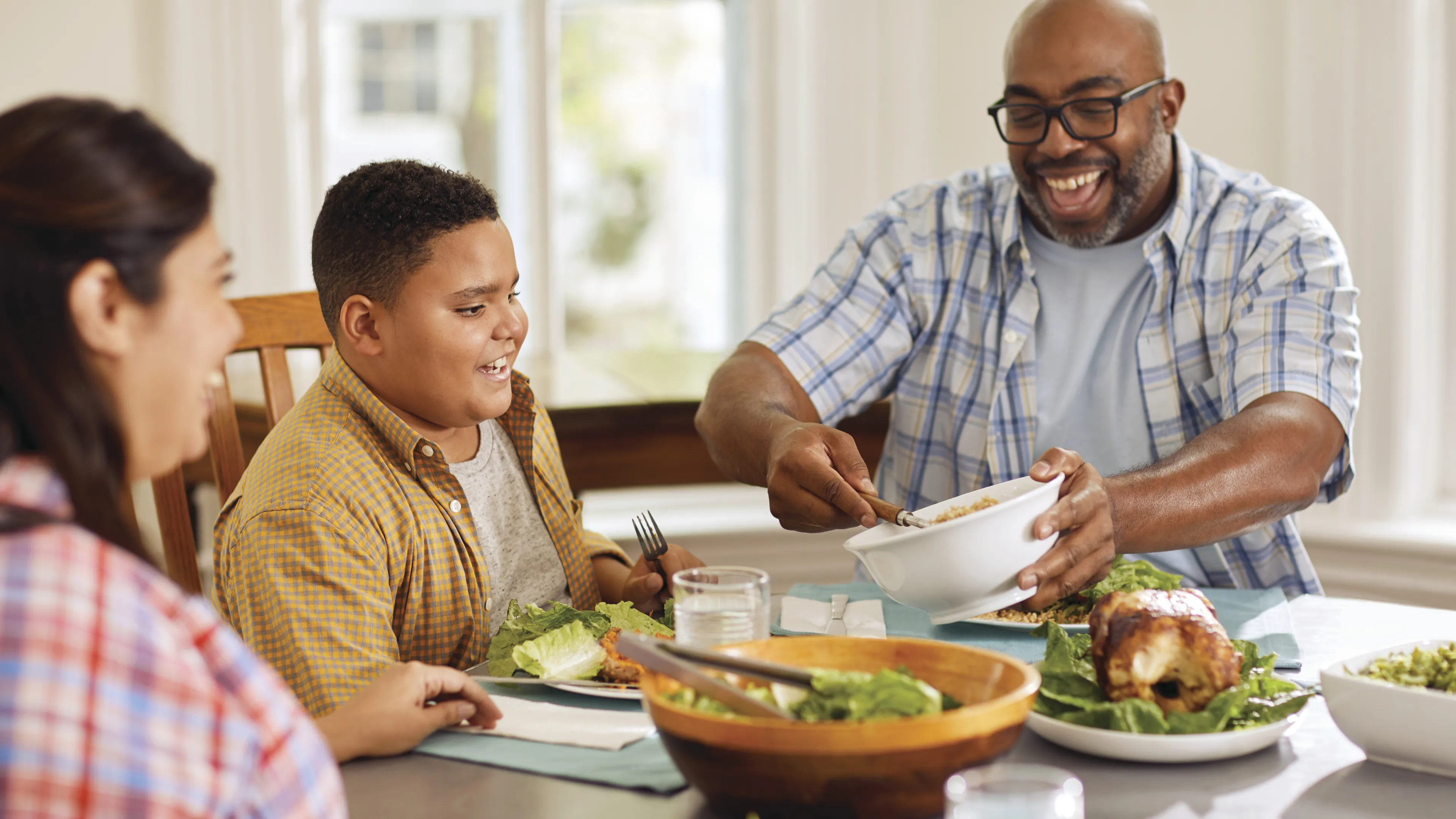 Two parents with a child having dinner