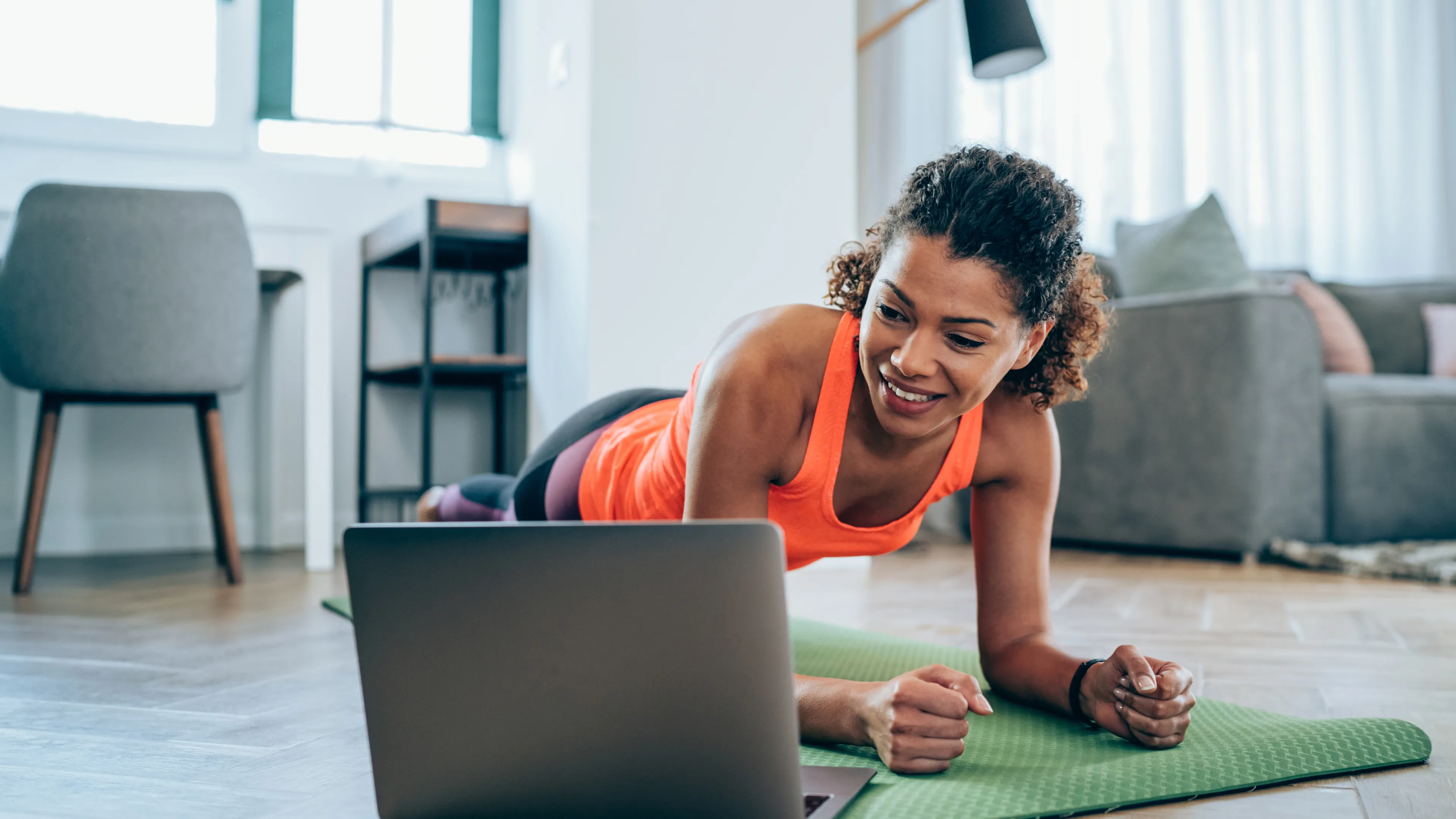 Women working out at home on computer