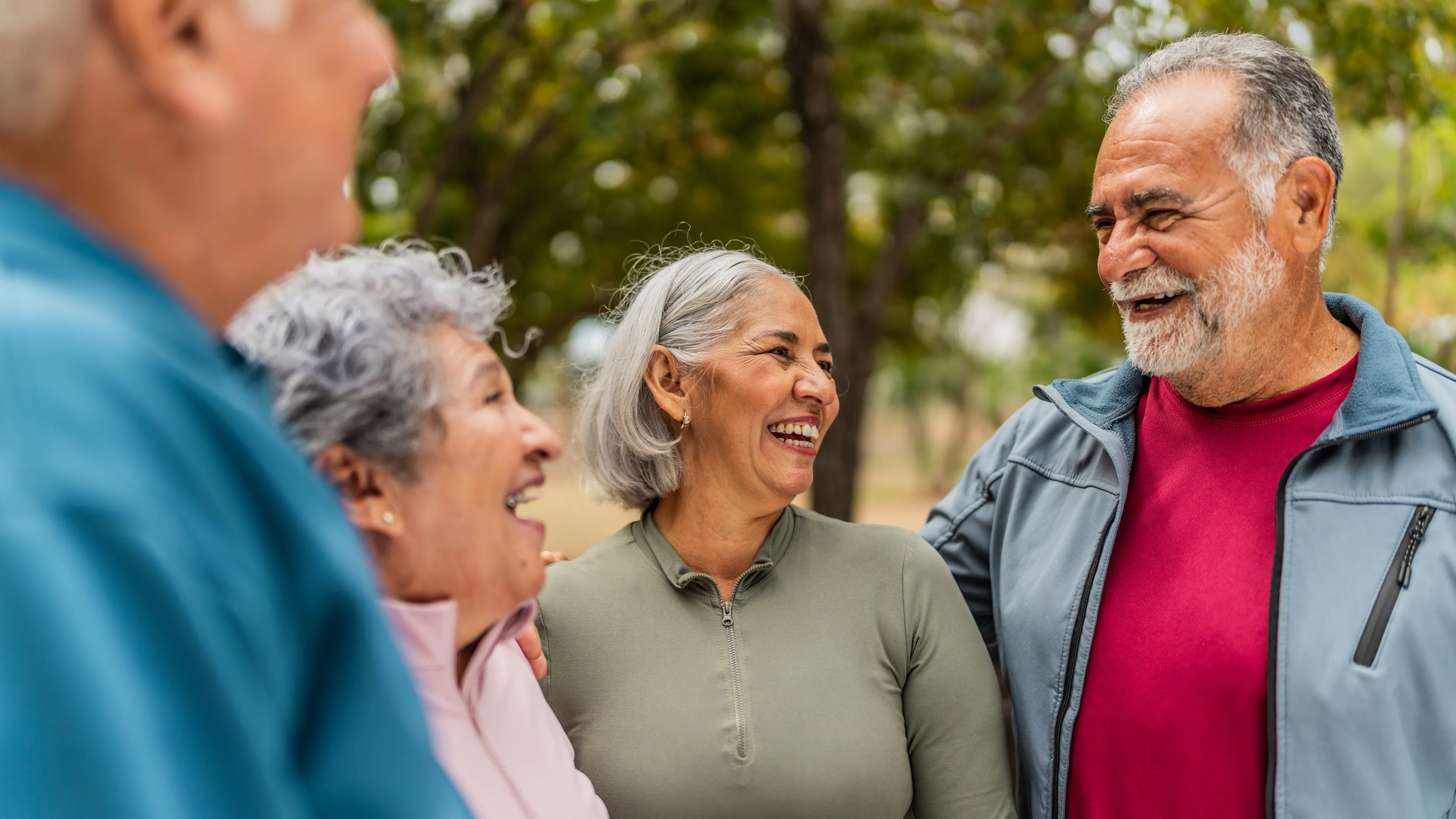 A group of active older adults, outdoors and laughing