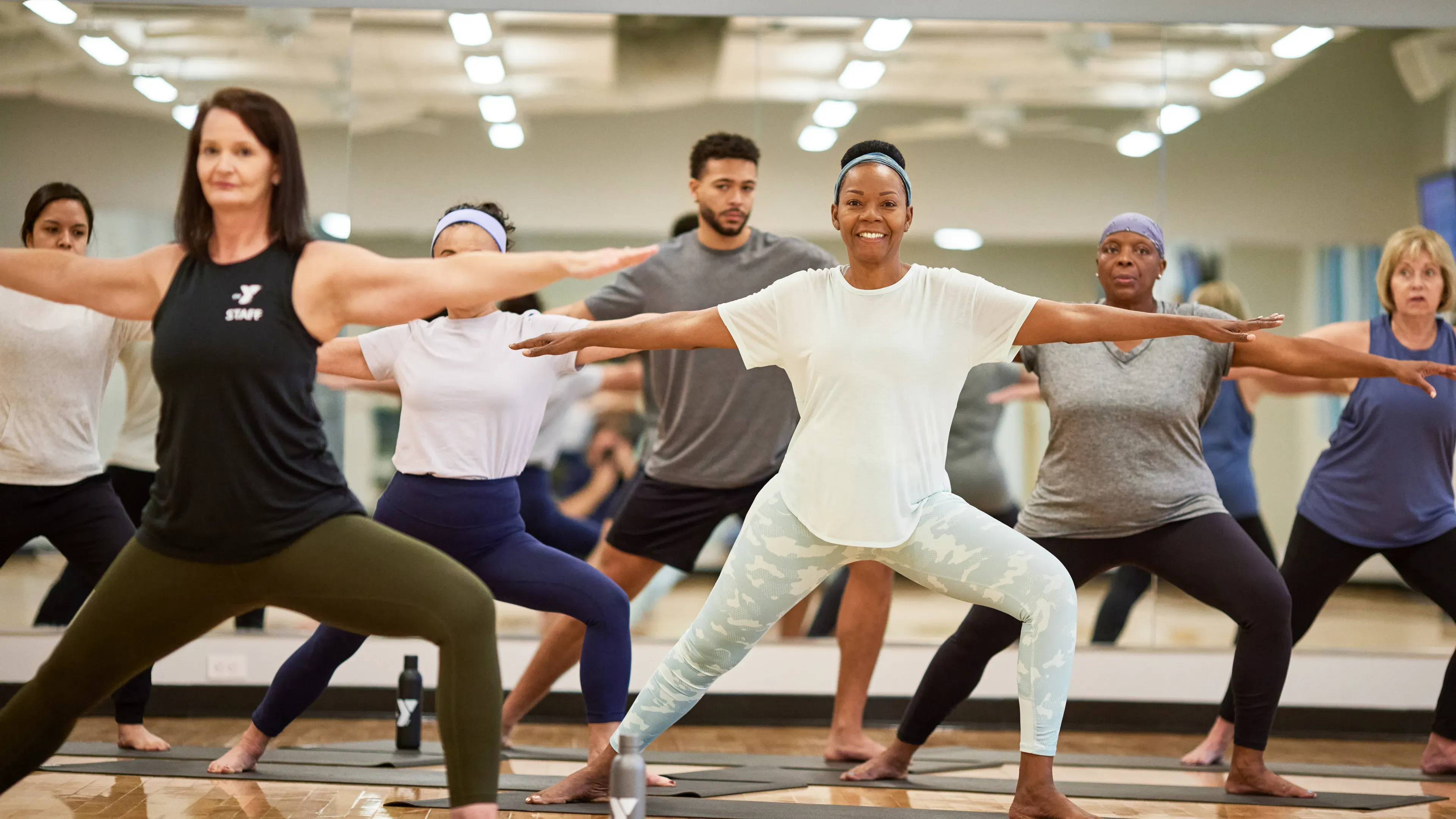 People doing yoga with a ymca instructor