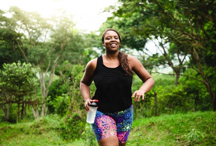 Body positive woman exercising in nature stock photo