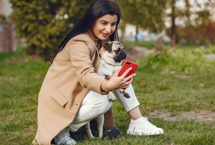 Teen Woman Brown Coat Holding Dog Taking Photo Selfie