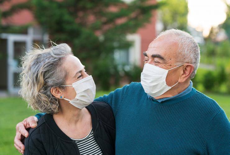 Older Senior Couple wear surgical masks