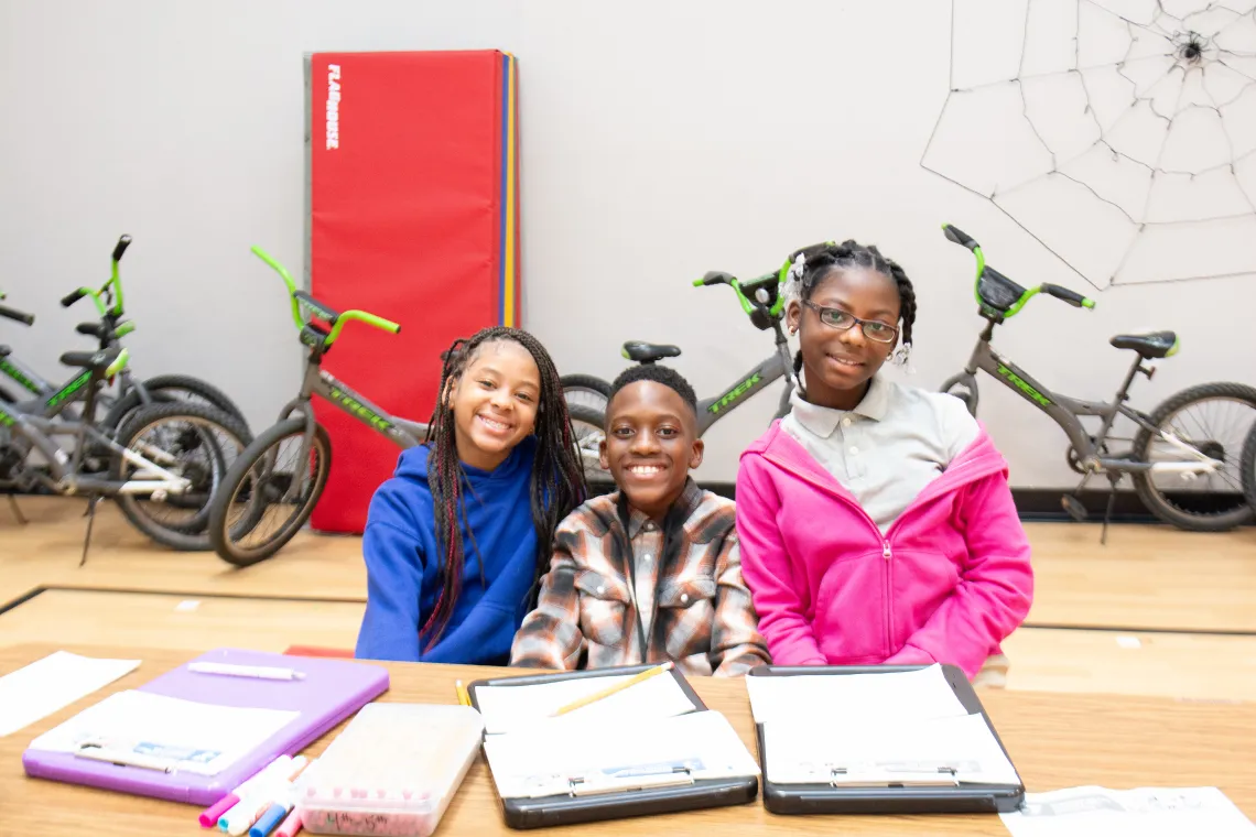 YMCA Afterschool kids focused on homework completion.