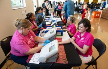 Woman receiving health and blood pressure screening