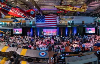 Ariel shot featuring the event venue, Frontiers of Flights Museum, event set up and attendees