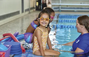 little girl smiling in the pool
