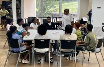 Teens sitting around a table learning about Mental Health
