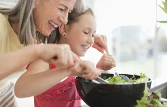 Grandmother and grand daughter cooking together