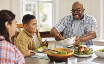 Two parents with a child having dinner