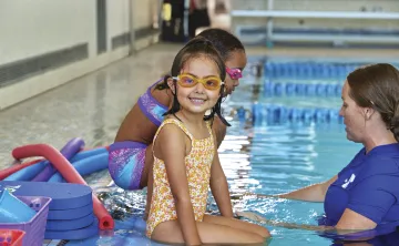 little girl smiling in the pool