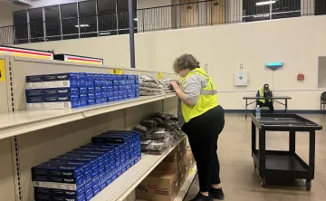 Teenager works to restock food before the market opens