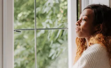 Woman look thoughtfully out the window