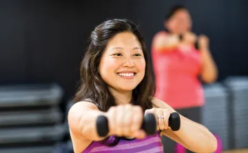 Lady holding weights during a group exercise class